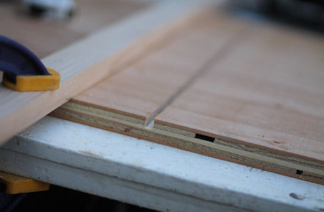 Use a straight edge and router to cut a groove in the plywood