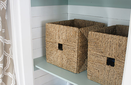 Use wicker baskets for storage on the finished shelves