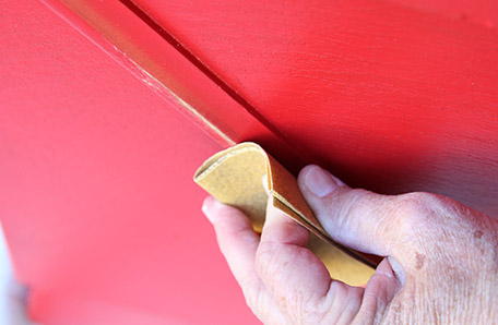 Use fine-grit sandpaper to rub off paint for a distressed look