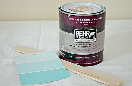A quart of Behr paint alongside a paint chip