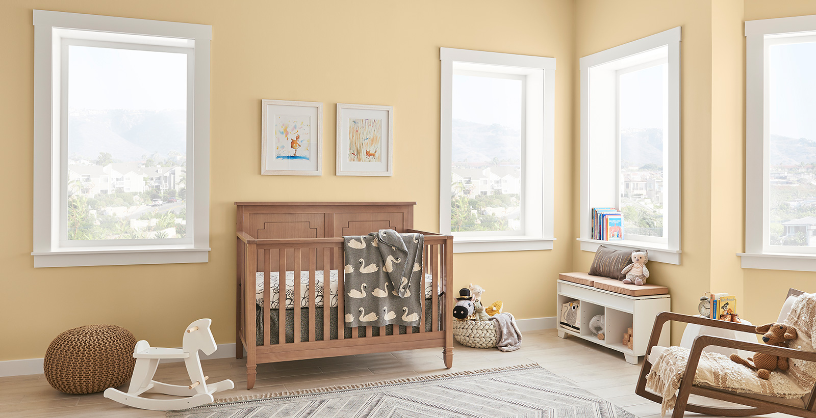 Youth room with yellow walls and white trim, wooden crib, casual style.