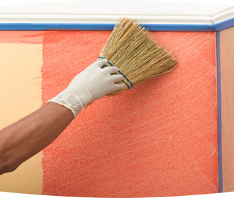 Person applying paint to a wall with a large paint brush
