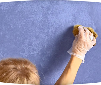 Person sponging the wall with paint