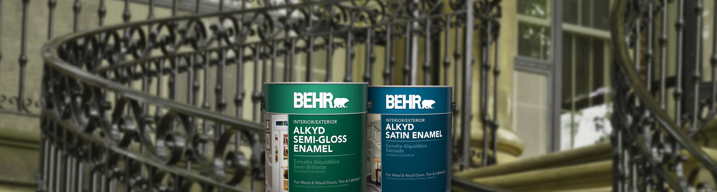 Two cans of Behr paint with metal railed stairs in the background