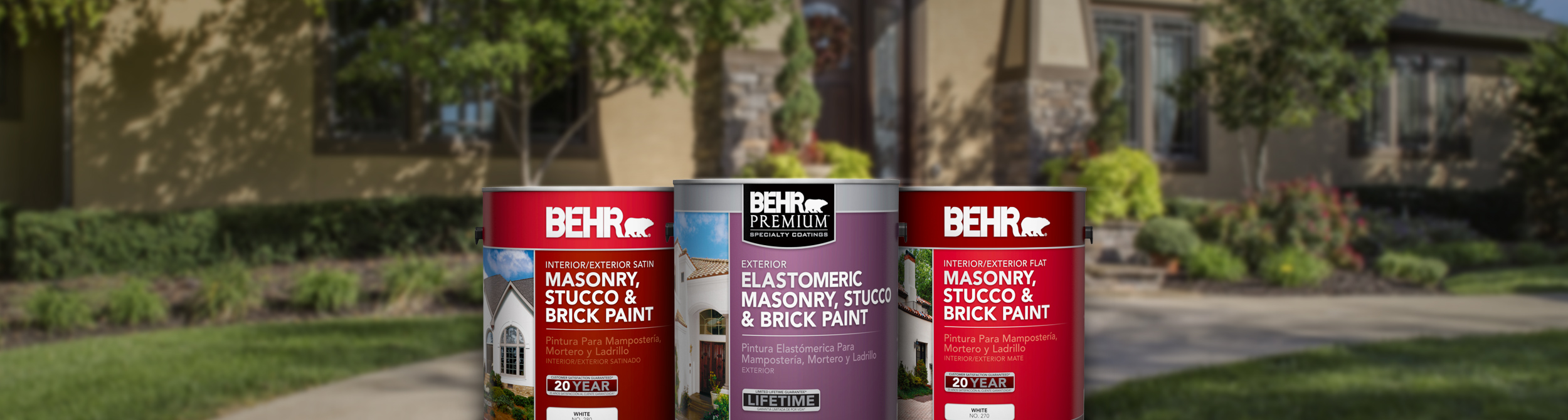 Three cans of Behr paint with large home and trees in the background