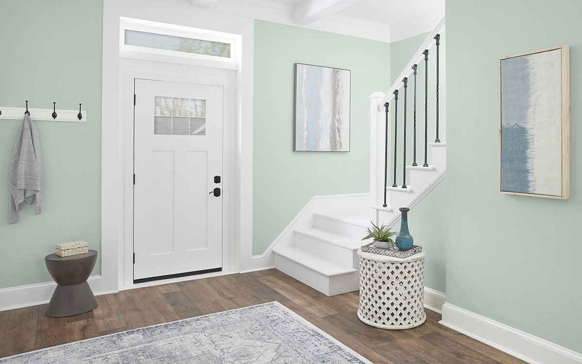 An entryway with the walls painted in a soft sea glass green hue.